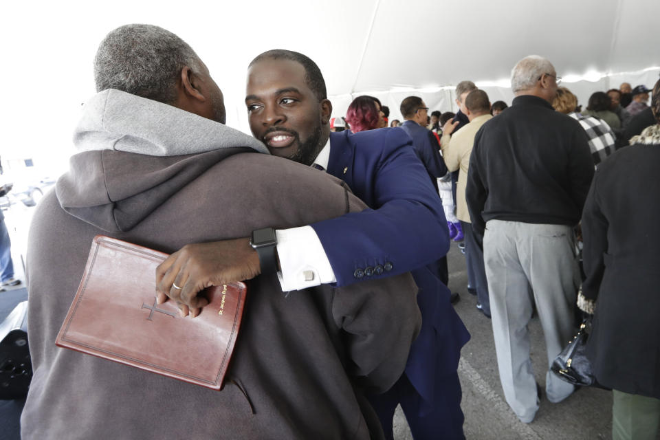 Pastor Jacques Boyd hugs worshipper Gene Hancock, left, after service at Mount Bethel Missionary Baptist Church, Sunday, March 8, 2020, in Nashville, Tenn. The congregation held their Sunday service in a tent in the parking lot near the church facilities, which were heavily damaged by a tornado March 3. (AP Photo/Mark Humphrey)