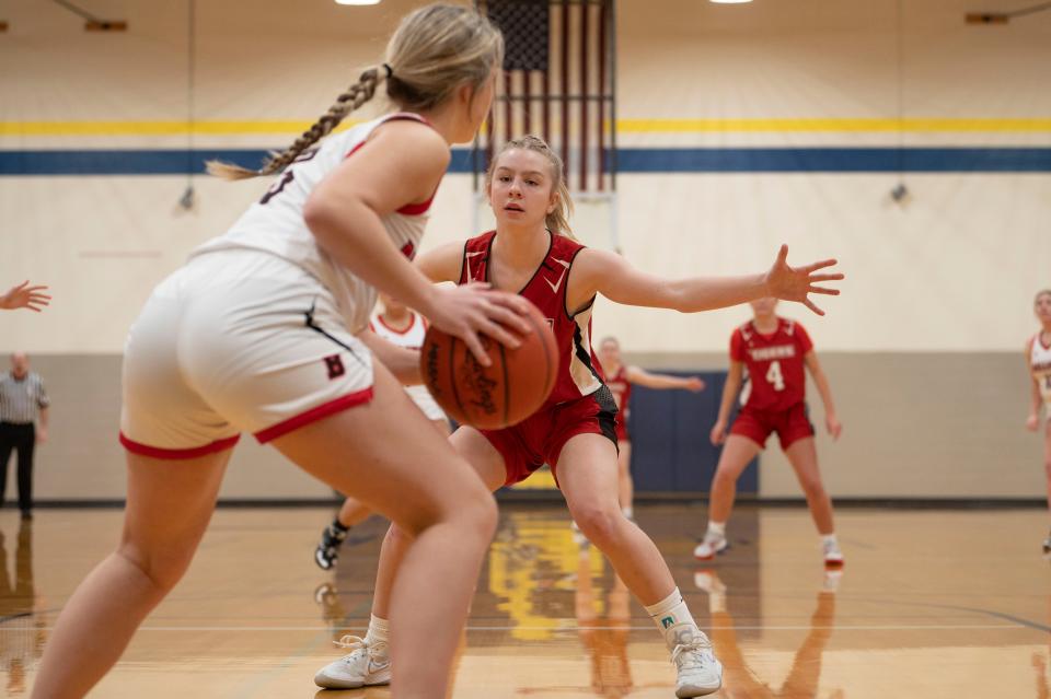 St. Philip junior Makenzee Grimm guards against Bellevue senior Nadia Vanhoose during a game at Climax-Scotts High School on Wednesday, March 1, 2023.