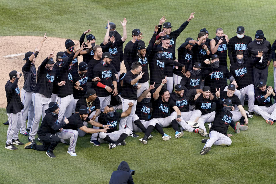 Members of the Miami Marlins celebrate after defeating the Chicago Cubs in Game 2 of a National League wild-card baseball series Friday, Oct. 2, 2020, in Chicago. The Marlins won the series 2-0 to advance to the division series. (AP Photo/Nam Y. Huh)