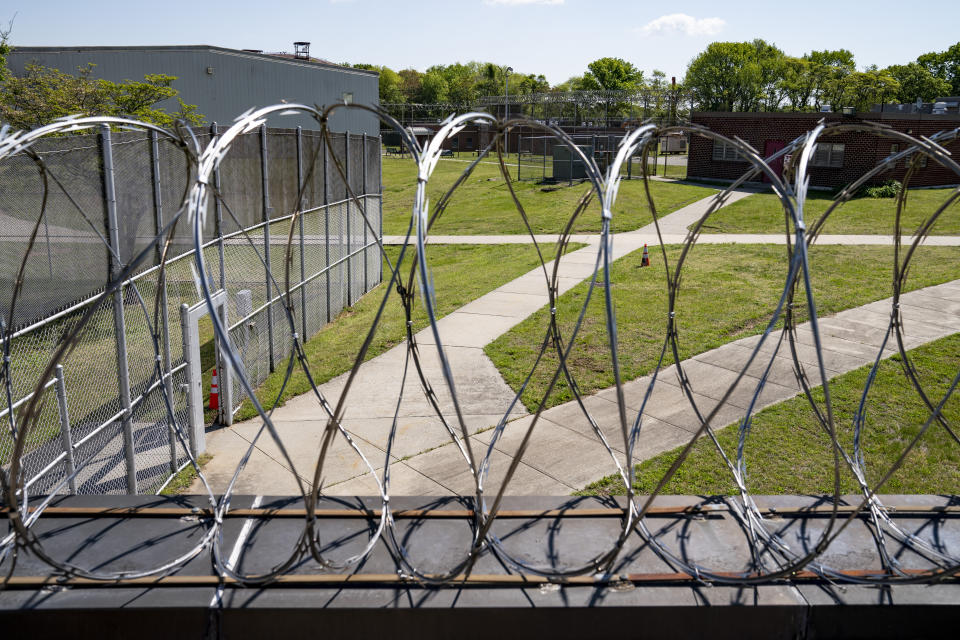 Razor wire surrounds the perimeter fencing and guard post at the former Arthur Kill Correctional Facility, Tuesday, May 11, 2021, in the Staten Island borough of New York. The facility was purchased by Broadway Stages in 2017 and has been transformed into a film and television studio. Much of the prison was preserved as a set, lending authenticity to scenes in productions. Five other sound stages are being built on the 69-acre site, giving production companies the ability to shoot entire projects. (AP Photo/John Minchillo)