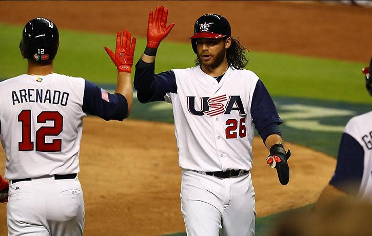 Brandon Crawford celebrates after scoring Team USA's first run. (AP)