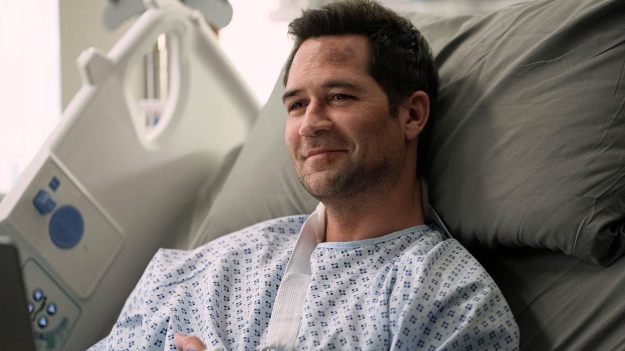  Manuel Garcia-Rulfo as Mickey laying in a hospital bed in The Lincoln Lawyer season 2 episode 6 