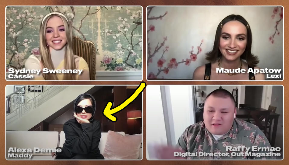 Alexa Demie sitting with sunglasses on in her living room while doing an interview