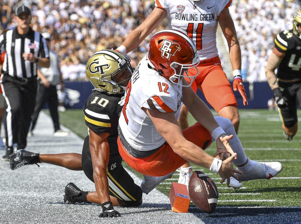 Bowling Green quarterback Camden Orth (12) loses control of the ball under pressure from Georgia Tech defensive back Kenan Johnson (10) at the goal line in the first half of an NCAA college football game, in Atlanta, Saturday, Sept. 30, 2023. (Daniel Varnado/Atlanta Journal-Constitution via AP)