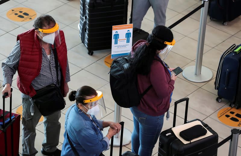 Passengers stand in line at the Tocumen International Airport during the coronavirus disease (COVID-19) outbreak, in Panama City