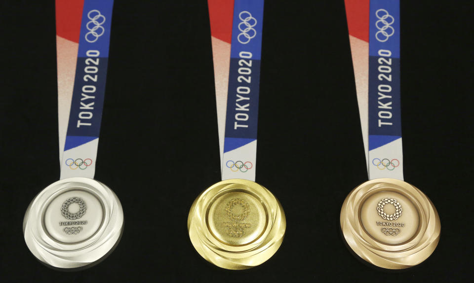 Tokyo 2020 Olympic medals are unveiled during a One Year to Go Olympic Ceremony Event in Tokyo Wednesday, July 24, 2019. Gold, silver, and bronze Olympic medals were to get their first public viewing on Wednesday as Tokyo organizers marked exactly a year until the games open. (AP Photo/Koji Sasahara)