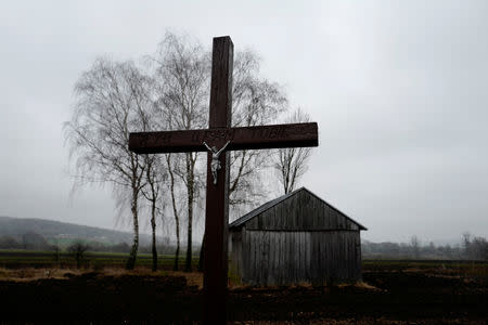 A cross is seen near a barn in Sulomice, near Kalinowka, Poland November 25, 2018. REUTERS/Kacper Pempel/Files
