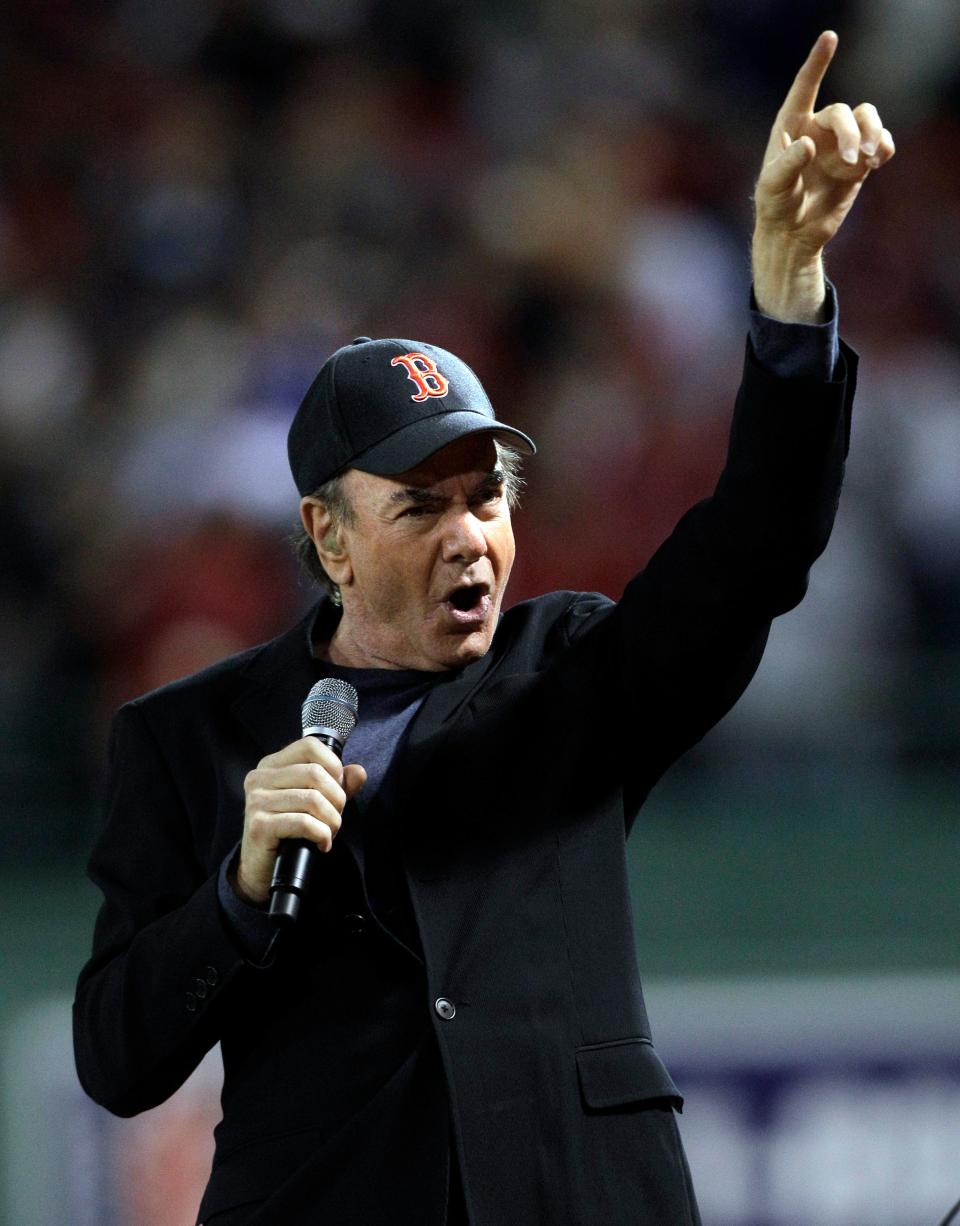 Neil Diamond sings "Sweet Caroline" in the middle of the eighth inning during the opening game of the baseball season between the Boston Red Sox and New York Yankees at Fenway Park in Boston on April 4, 2010.