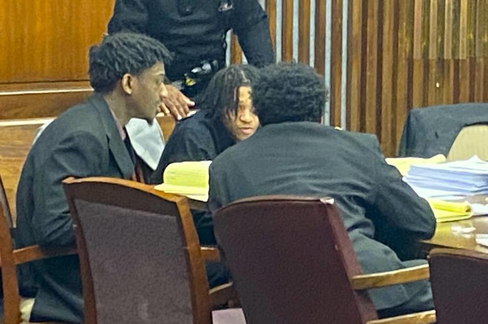 Left to right, defendants Corey Troupe and Davion Dupas talk to Jahiem Davis.