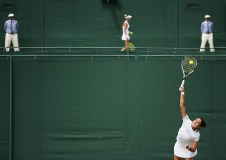 Zarina Diyas of Kazakhstan (foreground) serves during her match against Flavia Pennetta of Italy as Vitalia Diatchenko of Russia looks on during her match against Anna-Lena Friedsam of Germany at the Wimbledon Tennis Championships in London, June 29, 2015. REUTERS/Stefan Wermuth TPX IMAGES OF THE DAY