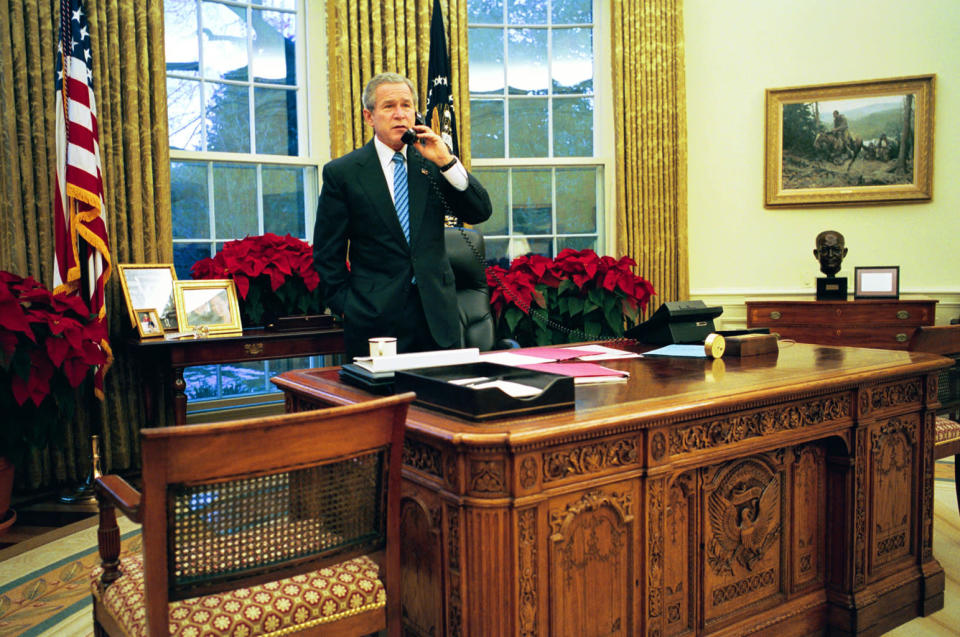 In this handout photo, U.S. President George W. Bush speaks to Canadian Prime Minister Paul Martin on the phone in the Oval Office in Iraq December 15, 2003 in Washington, D.C. (Photo by Eric Draper/White House via Getty Images)