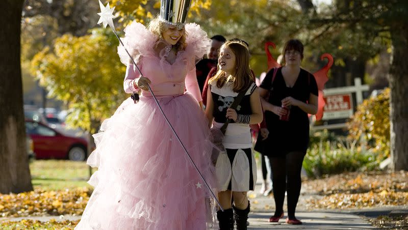 Glenda the Good Witch (Linda Collard) and a dead cheerleader (Mysharleigh Savas, 9) lead a group of trick-or-treaters up 9th South during the first annual “No Bones About It” Halloween trick-or-treating event at 9th and 9th on Oct. 31, 2007.