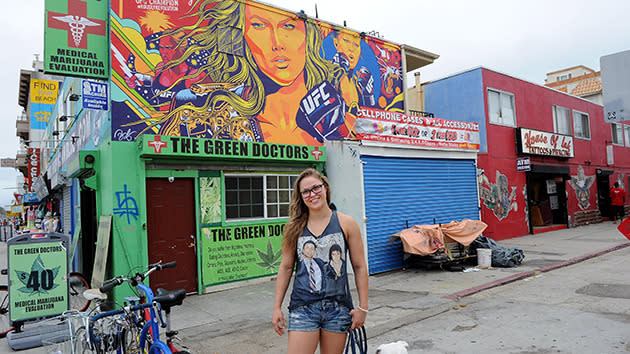 <p>Rousey poses in front of a mural painted in her honour in Venice Beach, L.A.</p>