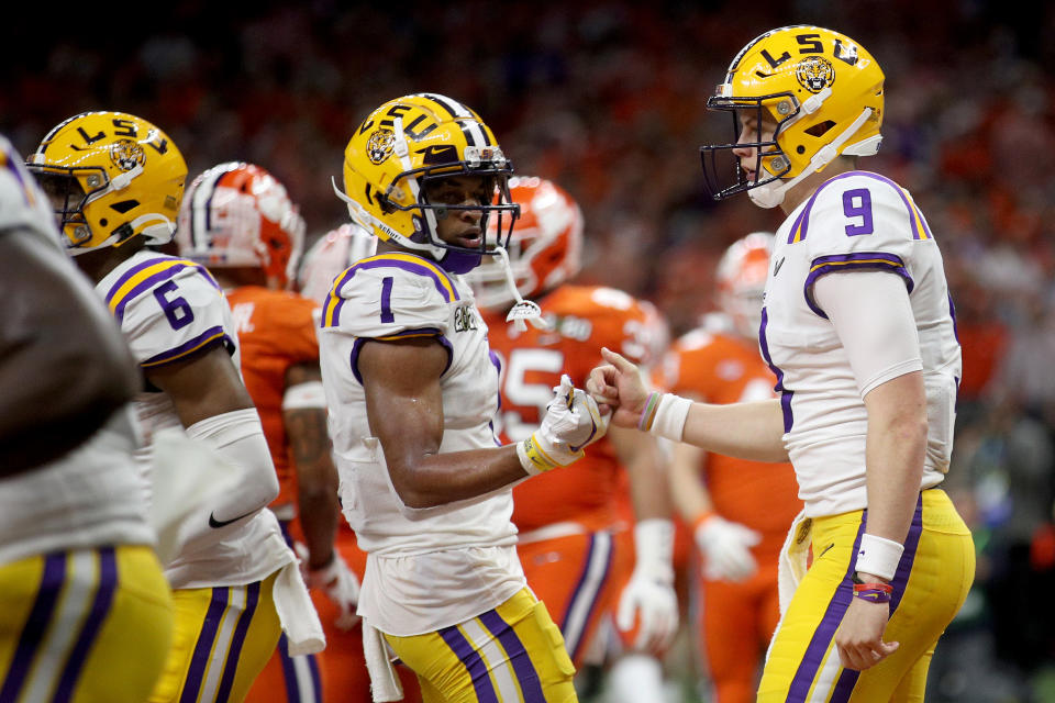 NEW ORLEANS, LOUISIANA - JANUARY 13: Joe Burrow #9 of the LSU Tigers celebrates with Ja'Marr Chase #1 of the LSU Tigers during the second quarter against the Clemson Tigers during the College Football Playoff National Championship game at Mercedes Benz Superdome on January 13, 2020 in New Orleans, Louisiana. (Photo by Chris Graythen/Getty Images)