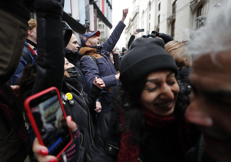 Julian Assange supporters celebrate after a ruling that he cannot be extradited to the United States, outside the Old Bailey in London, Monday, Jan. 4, 2021. A British judge has rejected the United States' request to extradite WikiLeaks founder Julian Assange to face espionage charges, saying it would be "oppressive" because of his mental health. District Judge Vanessa Baraitser said Assange was likely to commit suicide if sent to the U.S. The U.S. government said it would appeal the decision. (AP Photo/Frank Augstein)