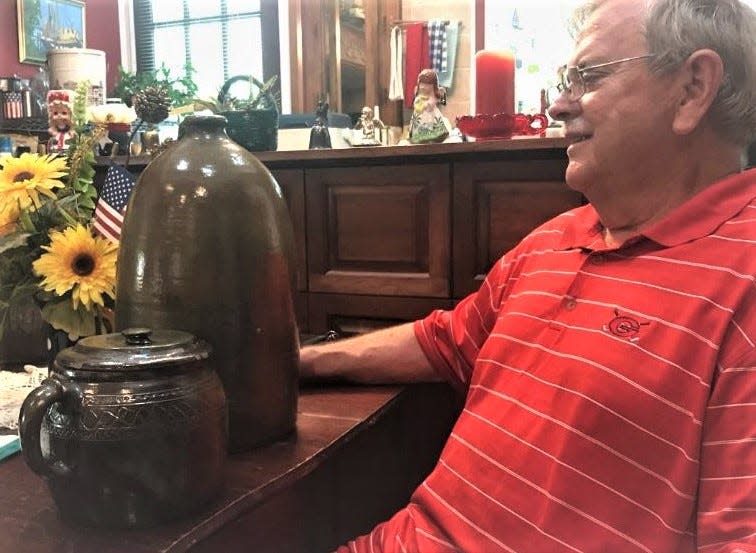 Bill McGraw with two pieces of pottery that were made at long forgotten pottery operations located between Bogart and Winder.