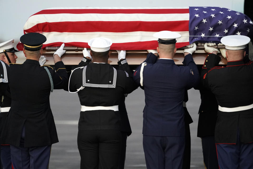 The flag-draped casket of former President George H.W. Bush is carried by a joint services military honor guard Wednesday, Dec. 5, 2018, at Ellington Field in Houston. (Photo: David J. Phillip, Pool/AP)