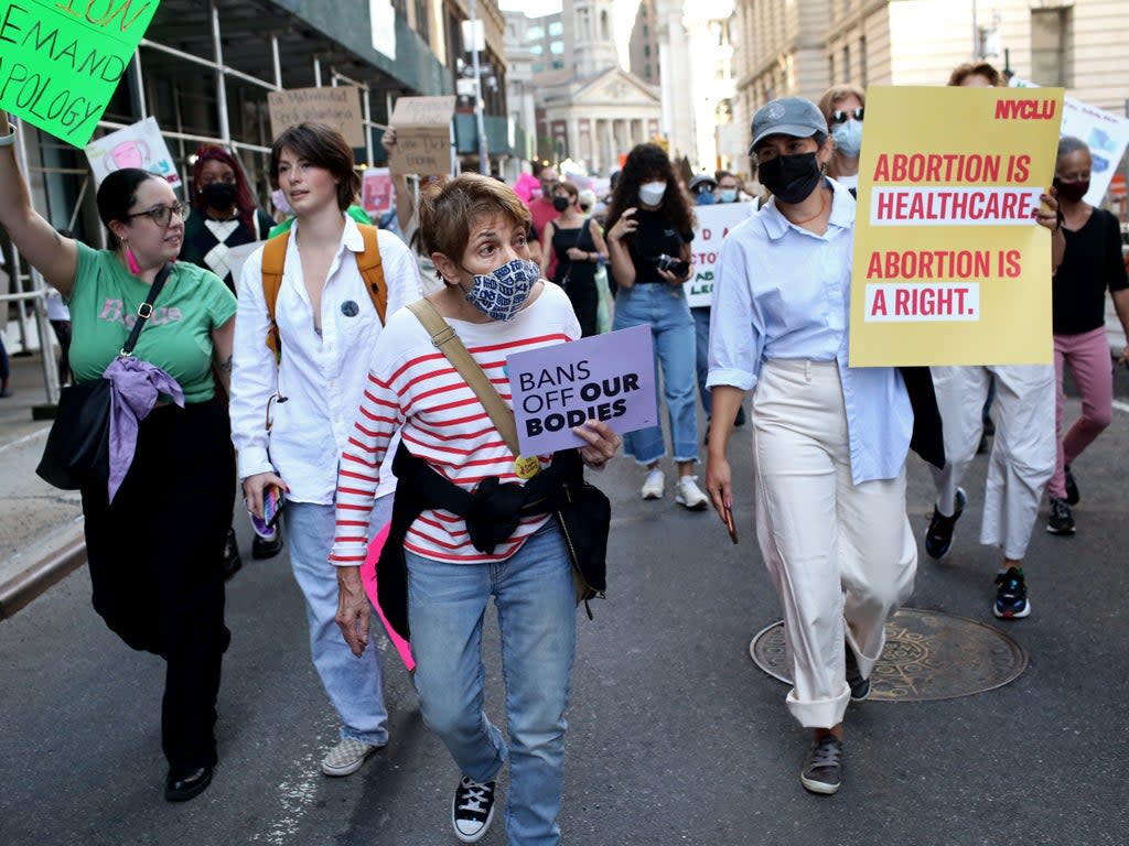 Crowds march toward Washington Square Park for the Women's March on October 2, 2021 in New York City (Getty Images)