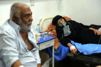 A coronavirus patient receives treatment at a hospital in Najaf, Iraq, Wednesday, July 14, 2021. Infections in Iraq have surged to record highs amid a third wave spurred by the more aggressive delta variant, and long-neglected hospitals suffering the effects of decades of war are overwhelmed with severely ill patients, many of them young people. (AP Photo/Anmar Khalil)