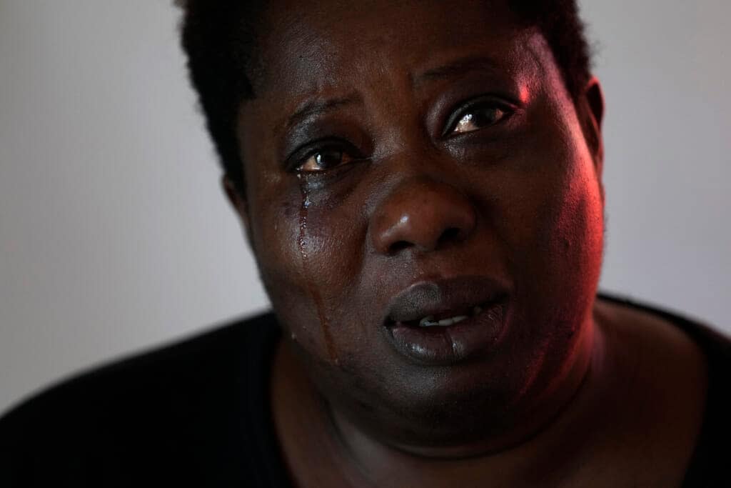 Charity Oriakhi, widow of a street vendor Alika Ogochukwu, cries during an interview with Associated Press at her home in San Severino Marche, Italy, Friday, Aug. 5, 2022. (AP Photo/Antonio Calanni)