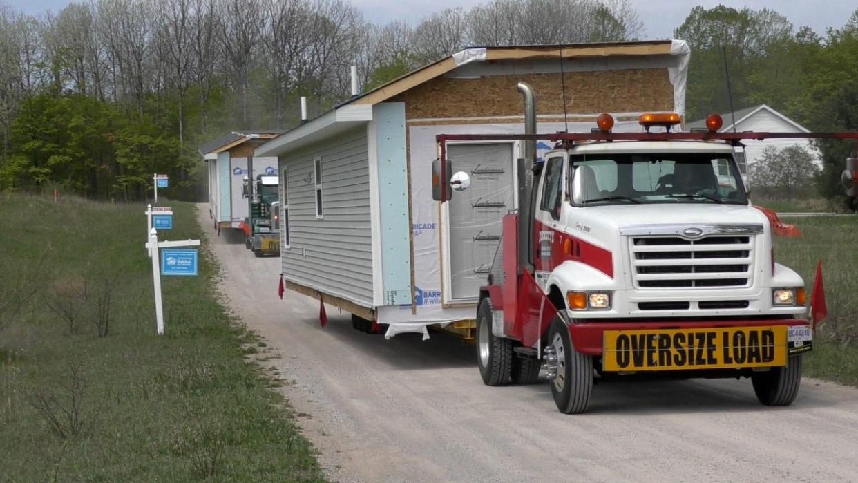 Modular homes are delivered to the Meadowlands Subdivision in Alanson in May.