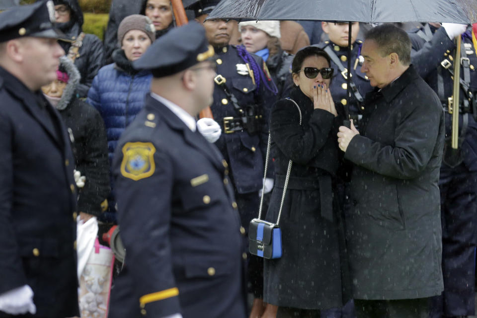 Family, friends and others arrive for the funeral of Jersey City Police Detective Joseph Seals in Jersey City, N.J., Tuesday, Dec. 17, 2019. Funeral services for Seals are scheduled for Tuesday morning. The 40-year-old married father of five was killed in a confrontation a week ago with two attackers who then drove to a kosher market and killed three people inside before dying in a lengthy shootout with police. (AP Photo/Seth Wenig)