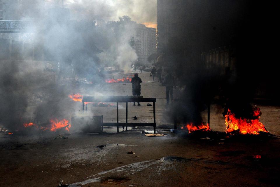 Heavy smoke billows the air due to clashes between supporters of Egypt’s ousted Islamist President Mohammed Morsi and security forces in Mediterranean city of Alexandria, Egypt, Friday, Jan. 3, 2014. The confrontations spilled from main streets to side streets in heavily populated residential areas in several provinces including Cairo, Giza and Alexandria. Dozens of Muslim Brotherhood members and supporters hurled rocks at security forces, which responded with volleys of tear gas. (AP Photo/Heba Khamis)