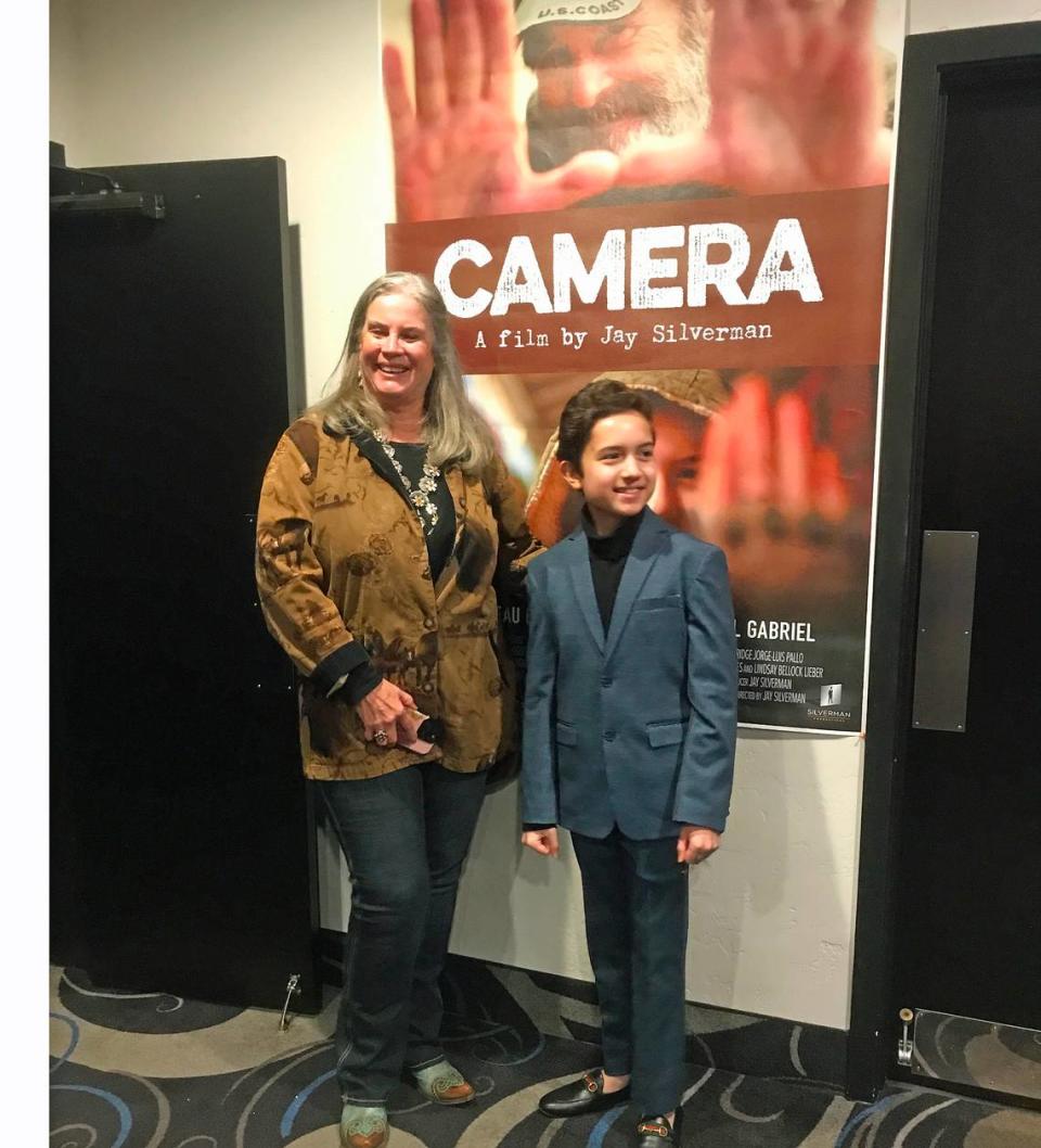 Morro Bay Mayor Carla Wixom and lead actor Miguel Gabriel post in front of the poster for “Camera,” the as-yet-unreleased Beau Bridges film introduced Jan. 20, 2024, at a charity screening in Morro Bay. Producer/director Jay Silverman said Wixom was key to getting permissions for the local filming and the screening.