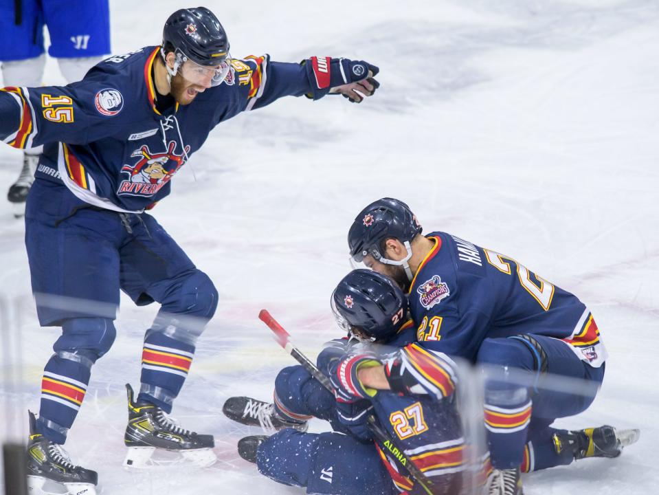 Peoria's Alex Carrier (15) and Jake Hamilton (21) celebrate with teammate Mike Gelatt after Gelatt's goal against Roanoke in the second period of Game 2 of the SPHL semifinals Friday, April 21, 2023 at Carver Arena.