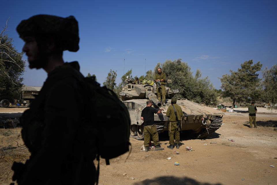Israeli soldiers gather in a staging area near the border with Gaza Strip, in southern Israel Tuesday, Oct. 17, 2023. (AP Photo/Ariel Schalit)