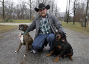 <p>Shane Johnson poses with his dogs outside his home in Tippecanoe, Ind., Jan. 12, 2017. Johnson was born into extremism. He eventually joined a skinhead group in addition to the KKK but finally decided to quit after getting arrested, stopping drinking and meeting the woman who is now his wife. Leaving was a real fight, though, as even relatives jumped him at a gas station one night after learning he wanted to quit. (Photo: Michael Conroy/AP) </p>