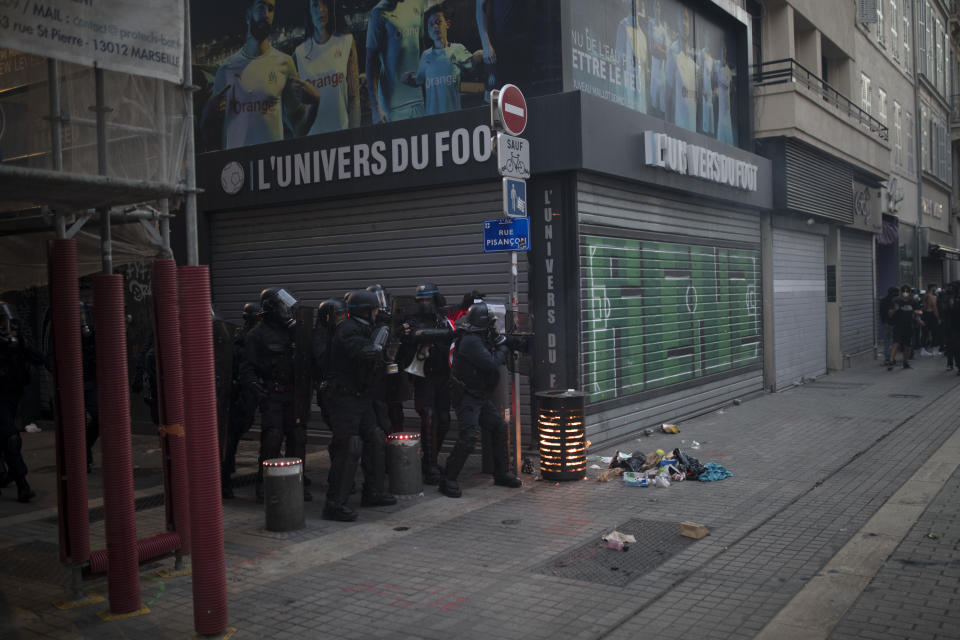 French riot police advance on protesters during a march against police brutality and racism in Marseille, France, Saturday, June 13, 2020, organized by supporters of Adama Traore, who died in police custody in 2016 in circumstances that remain unclear despite four years of back-and-forth autopsies. Several demonstrations went ahead Saturday inspired by the Black Lives Matter movement in the U.S. (AP Photo/Daniel Cole)