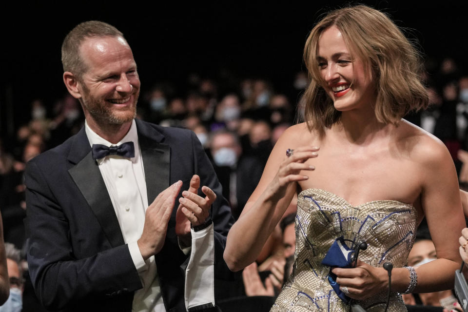 Joachim Trier, left, and Renate Reinsve, winner of the award for best actress for the film 'The Worst Person in The World' appear in the audience during the awards ceremony at the 74th international film festival, Cannes, southern France, Saturday, July 17, 2021. (AP Photo/Vadim Ghirda)