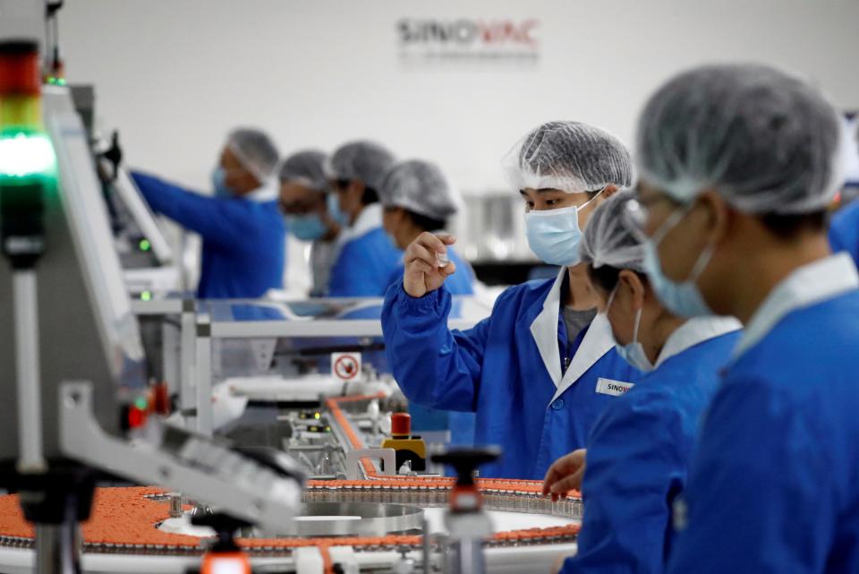 Workers are pictured on 24 September, 2020, at a packaging facility owned by Sinovac, the company that is developing the CoronaVac vaccine.  (REUTERS)