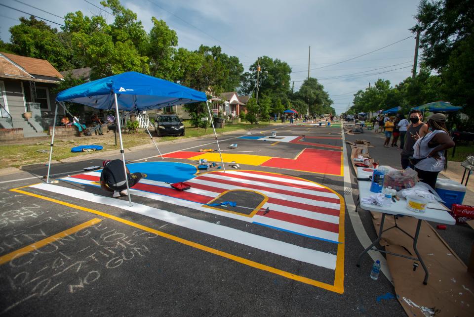 Painters work on a Black Lives Matter mural on A Street in Pensacola on June 27, 2020.
