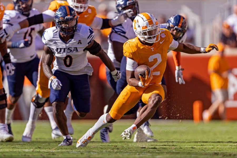 Tennessee running back Jabari Small (2) outruns UTSA safety Rashad Wisdom (0) during the first half of an NCAA college football game Saturday, Sept. 23, 2023, in Knoxville, Tenn. (AP Photo/Wade Payne)