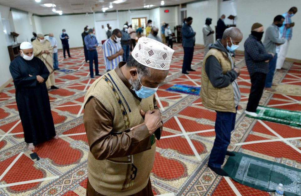 Ali Abdalla, center, and other men give their final prayer of the day on Tuesday, March 30, 2021 at the Islamic Center of Charlotte.