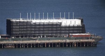 A barge built with four levels of shipping containers is seen at Pier 1 at Treasure Island in San Francisco, California October 28, 2013. How badly does Google want to keep under wraps a mysterious project taking shape on a barge in San Francisco Bay? Badly enough to require U.S. government officials to sign confidentiality agreements. REUTERS/Stephen Lam