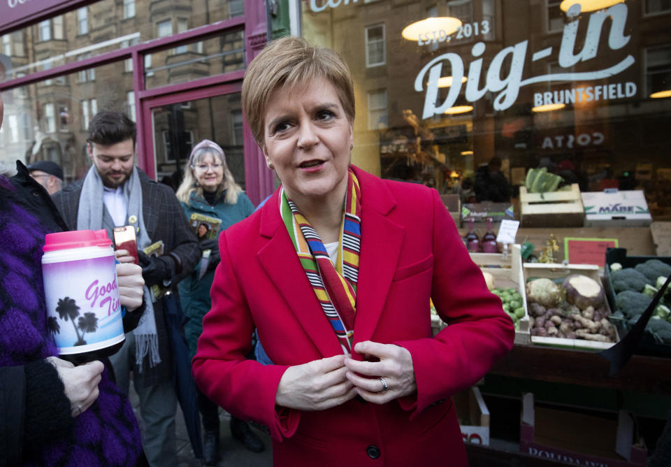 SNP leader Nicola Sturgeon, poses for a photo, during a visit to Digin Community Greengrocer in Edinburgh, Scotland, on the last day of the General Election campaign trail, Wednesday, Dec. 11, 2019. Britain goes to the polls on Dec. 12. (Jane Barlow/PA via AP)