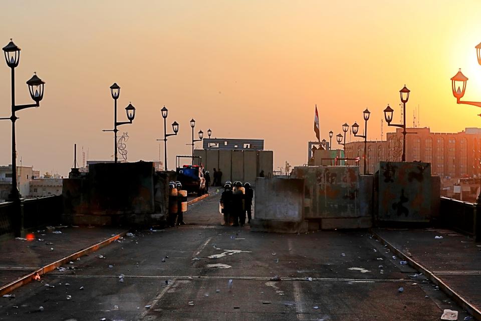 Riot police close the Ahrar Bridge, in Baghdad, Iraq, Sunday, Nov. 17, 2019. Protesters retook control of half of Ahrar Bridge, which leads to the other side of the Tigris River near the heavily fortified Green Zone, the seat of Iraq's government. Anti-government protesters in Iraq seized control of a third strategic Baghdad bridge on Sunday. (AP Photo/Khalid Mohammed)