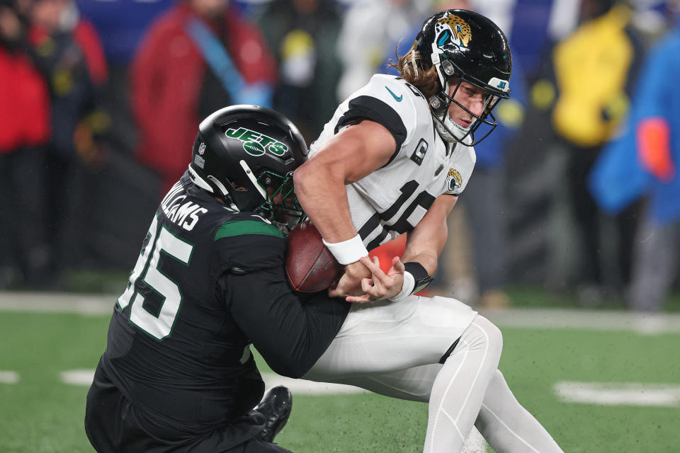 Dec 22, 2022; East Rutherford, New Jersey, USA; Jacksonville Jaguars quarterback Trevor Lawrence (16) is sacked by New York Jets defensive tackle <a class="link " href="https://sports.yahoo.com/nfl/players/31835" data-i13n="sec:content-canvas;subsec:anchor_text;elm:context_link" data-ylk="slk:Quinnen Williams;sec:content-canvas;subsec:anchor_text;elm:context_link;itc:0">Quinnen Williams</a> (95) forcing a fumble during the first half at MetLife Stadium. Mandatory Credit: Vincent Carchietta-USA TODAY Sports