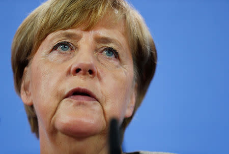 German Chancellor Angela Merkel leaves after addressing the media in Berlin, Germany, August 18, 2017. REUTERS/Hannibal Hanschke