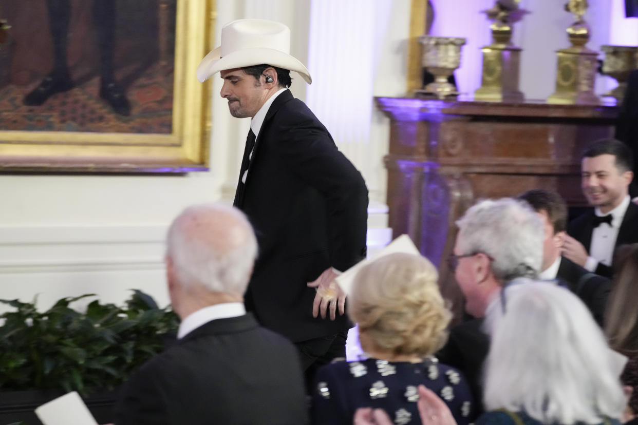 Country music singer Brad Paisley walks to the stage to perform before President Joe Biden, left, and first lady Jill Biden in the East Room of the White House following a dinner reception for National Governors Association members, Saturday, Feb. 11, 2023, in Washington. (AP Photo/Manuel Balce Ceneta)