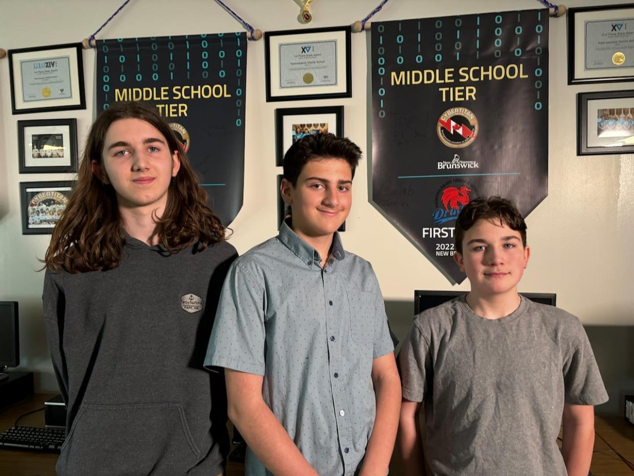 From left, Caleb Jeffries, Jneid Eljneid and Jude Clowater are members of the small but mighty team, the CyberDragons. They are returning national CyberTitan champions. (Hannah Rudderham/CBC - image credit)