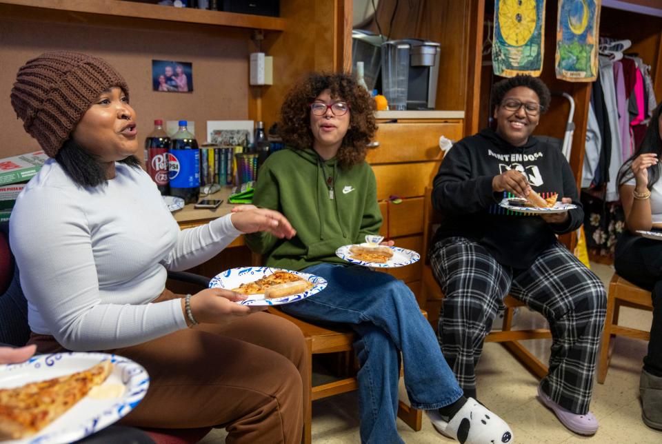 Lavita Johnson, Jana Ruiz-Alvarado, and Sarah Shanklin have a laugh over pizza in the dorm room of Abigail Turner on Wednesday, Jan. 31, 2024, on the University of Indianapolis campus. Turner has Retinitis pigmentosa, a rare disease that contracts her vision to a small spot at the center of her vision.