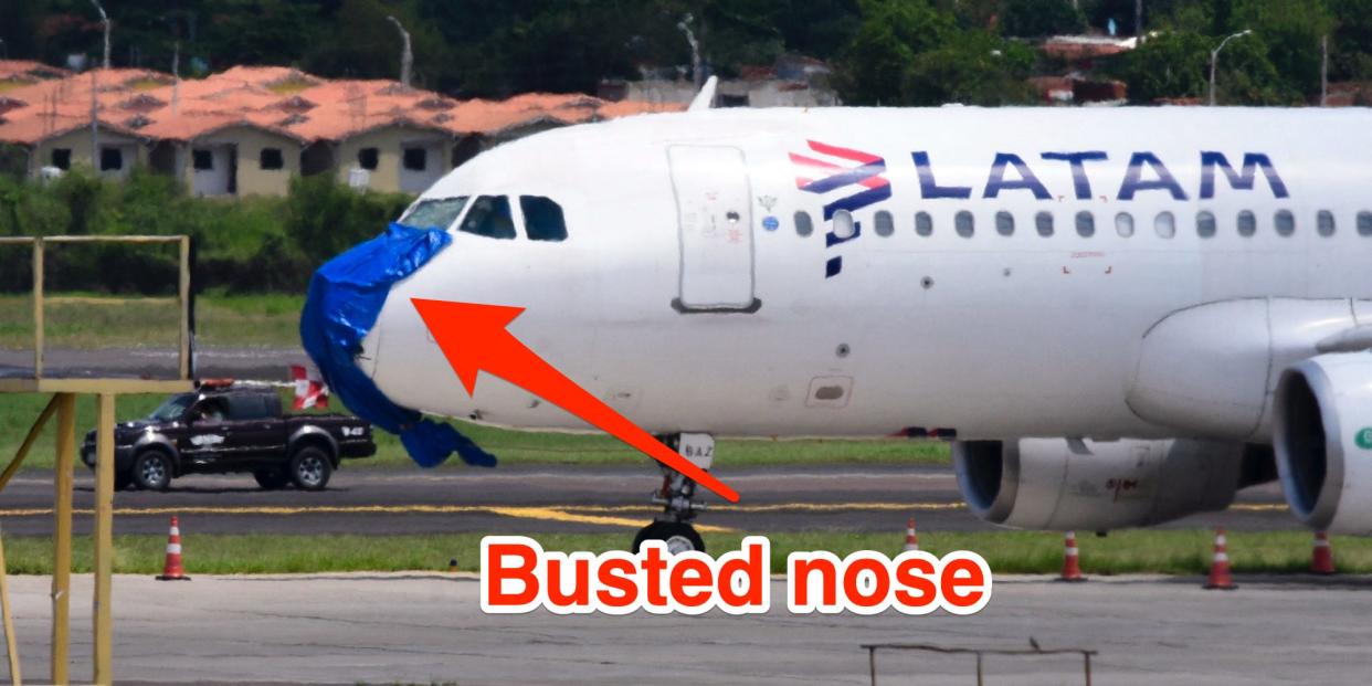 A Latam Airlines plane with a blue covering on its broken nose cone after an emergency landing Silvio Pettirossi International Airport in Luque, Paraguay, on October 27, 2022. Insider added an arrow and text saying "busted nose"