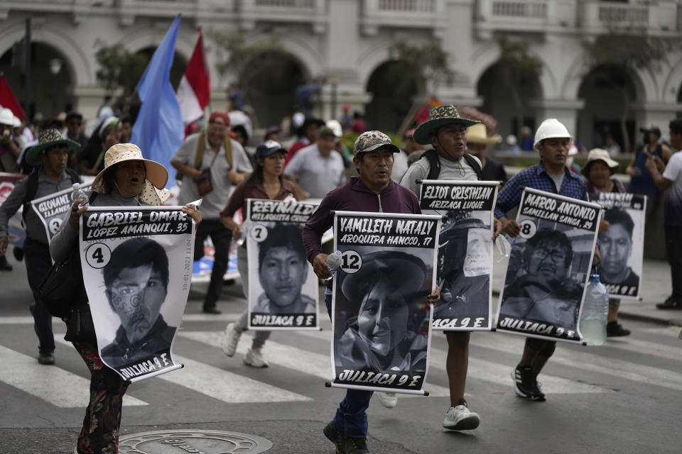 Anti-government protesters march with posters showing images of the more than 40 people who have died during clashes with police amid the country's unrest, in Lima, Peru, Saturday, Jan. 28, 2023. Protesters are seeking immediate elections, President Dina Boluarte's resignation, the release of ousted President Pedro Castillo and justice for protesters killed in clashes with police. (AP Photo/Martin Mejia)