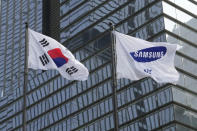 A Samsung Group flag, right, and South Korean national flag flutter at the company's office in Seoul, South Korea, Tuesday, April 30, 2024. Samsung Electronics on Tuesday reported a 10-fold increase in operating profit for the last quarter as the expansion of artificial intelligence technologies drives a rebound in the markets for computer memory chips.(AP Photo/Ahn Young-joon)