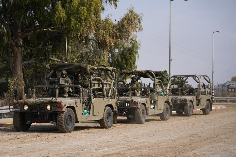 Israeli soldiers drive by the rave party site, where scores were killed, near the Kibbutz Re'im, close to the Gaza Strip border fence, on Tuesday, Oct.10, 2023. Israel's rescue service Zaka said paramedics had recovered at least 260 bodies of people attending the party who were killed in a surprise attack by Hamas militants Saturday. (AP Photo/Ohad Zwigenberg)