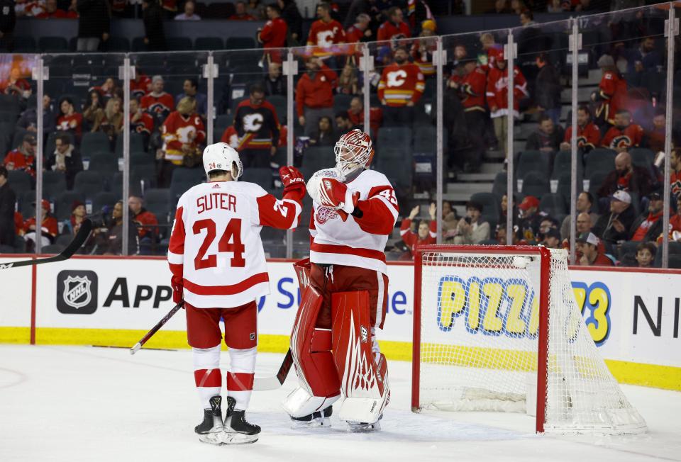 Magnus Hellberg and Pius Suter of the Detroit Red Wings celebrate a 5-2 win against the Calgary Flames  at the Scotiabank Saddledome in Calgary Alberta, on Thursday, Feb. 16, 2023.